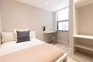 Bed desk chair plant open wardrobe bedroom at 74 Woodcroft Road in Liverpool Student Accommodation