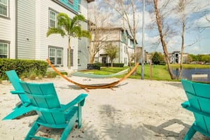 Hammock and chairs on sand exterior at Orion on Orpington in Orlando Student Accommodation