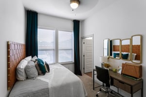 Bed with desk and mirrors bedroom at Berkeley House in College Station Student Accommodation