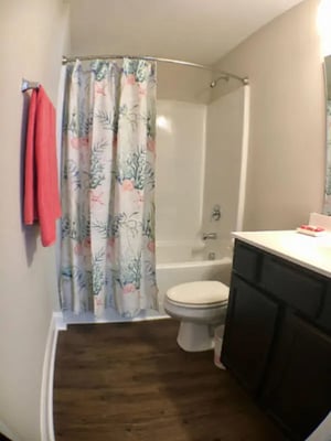 Toilet shower tub vanity and towels bathroom at Seahawk Cove in Wilmington Student Accommodation