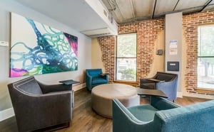 Modern seating area with large abstract art living room at The Warehouse Apartments Chapel Hill in Chapel Hill Student Accommodation