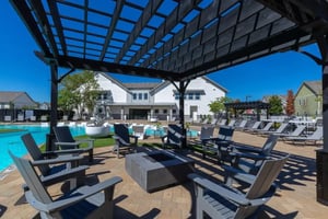 Chairs fire pit by pool with building exterior at The Collective at Columbia Apartments in Columbia Student Accommodation