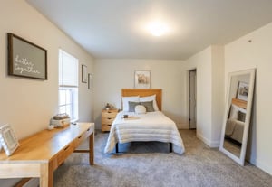 Bed with desk mirror and wall art bedroom at Copper Beech Townhomes - Ames in Ames Student Accommodation