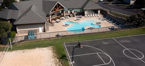 Swimming pool with loungers basketball court exterior at Copper Beech Townhomes - Harrisonburg in Harrisonburg Student Accommodation