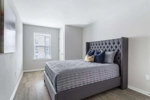 Tufted headboard grey bed with pillows bedroom at Bridge at Cameron in Austin Student Accommodation