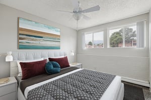 Tufted headboard bed ceiling fan artwork bedroom at Wind River Place Apartments in Colorado Springs Student Accommodation