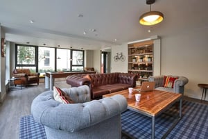Chesterfield sofas pool table leather chairs living room at The Ballet School in Glasgow Student Accommodation
