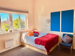 Bed desk kitchen and shelves studio apartment at AXO Paradise Student Village in Coventry Student Accommodation