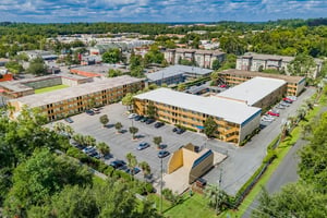 Apartment buildings with parking lot exterior at Campus Walk Tallahassee in Tallahassee Student Accommodation