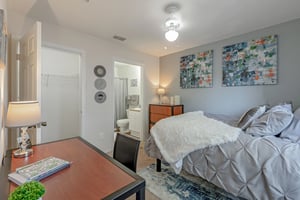 Bed desk chair art and closet bedroom at College Station Orlando in Orlando Student Accommodation