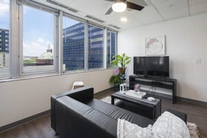 Black sofa coffee table tv plants living room at 220 Madison in Tampa Student Accommodation
