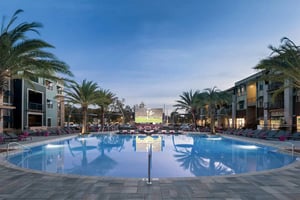 Resort style pool lounge chairs outdoor screen playing area exterior at Urban Enclave in Tallahassee Student Accommodation