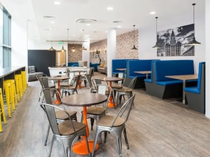 Tables booths pool table and chairs common area at Yugo Ablett House in Liverpool Student Accommodation