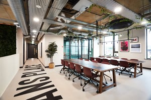 Communal tables with chairs and artwork Living room at Vita Student St.Albans in Leeds Student Accommodation