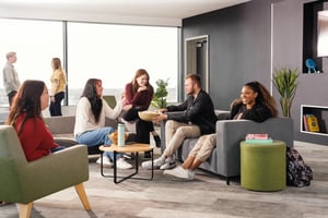 Students chat on couches with popcorn and drinks living area at Greetham Street in Portsmouth Student Accommodation