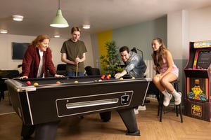 Students playing billiards and arcade game area at Joseph Stones House in Leeds Student Accommodation