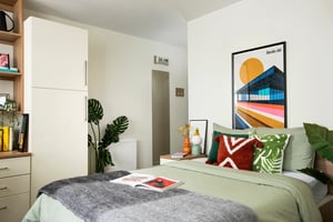 Bed with plants poster and dresser bedroom at Moonraker Point in London Student Accommodation