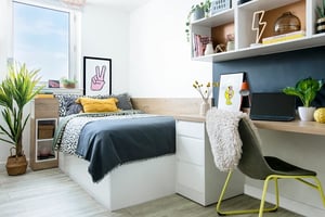 Bed desk plant artwork and chair bedroom at Walmsley Studios in London Student Accommodation
