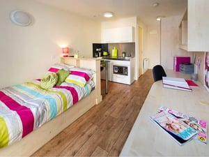 Bed sofa desk kitchen area living room at Optima in Loughborough Student Accommodation