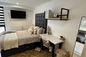 Bed TV desk shelf mirror kitchen area bedroom at Bridge Street Studios in Birmingham Student Accommodation