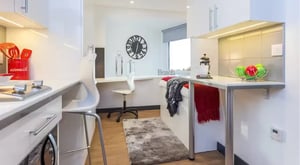 Bed with red throw and pillows study area at The Court Yard in Southampton Student Accommodation