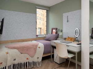 Bed desk ring light and chair bedroom at The Curve in London Student Accommodation
