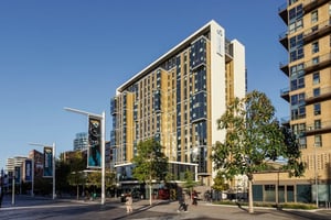 Modern student accommodation building with banners exterior at Olympic Way in London Student Accommodation