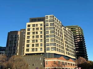 Student accommodation buildings with visible signage exterior. at Yugo University Square Melbourne in Melbourne Student Accommodation