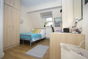 Bed desk and wardrobe student bedroom at Oxney House & Gardens in Manchester Student Accommodation