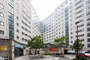 Courtyard with buildings benches trees exterior at Grand Central in Liverpool Student Accommodation