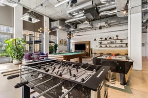Foosball and pool tables with seating communal area at Chapter White City in London Student Accommodation