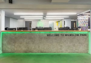 Welcome desk with computers and reception area at iQ Wilmslow Park in Manchester Student Accommodation