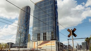Modern glass skyscrapers with railway crossing sign exterior at The Archive - Residential Living in Melbourne Student Accommodation
