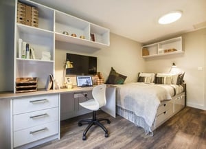 Desk bed shelves and television bedroom at Halsmere Studios in London Student Accommodation