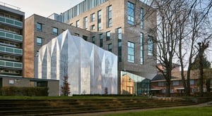 Modern brick building with reflective facade exterior at Townhall Camberwell in London Student Accommodation