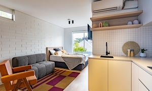 Bed sofa kitchen with sink and tap study area at UKO Balmain in Sydney Student Accommodation
