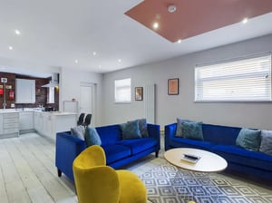 Blue sofas yellow chair modern kitchen living room at 8 Bedroom House at 211, Molyneux Road in Liverpool Student Accommodation