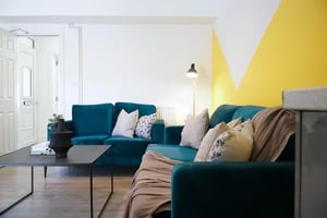 Teal sectional sofa with throw pillows living room at 6 Bedroom House at 23, Haydn Avenue in Manchester Student Accommodation