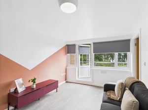 Sofa and burgundy cabinet with plant living room at 1 Bedroom House at Flat 6, Grove Street Studios, The Groves in Liverpool Student Accommodation