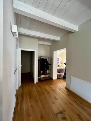 Hallway with coat rack wooden floor and doors Hallway at Welcoming double ensuite bedroom near the Vezzano Ligure train station in La Spezia Student Accommodation