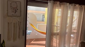 Hammock on balcony with wall art exterior at 1-bedroom flat in Armação de Pêra with balcony all electric no Gas in Silves Student Accommodation