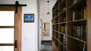 Wooden sliding door, bookcase, mirrors, hallway interior at Welcoming 2-bedroom apartment near the Albenga train station in Albenga Student Accommodation