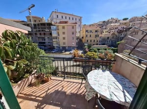 Table chairs plants and buildings exterior at Apartment with Terrace in Imperia in Imperia Student Accommodation