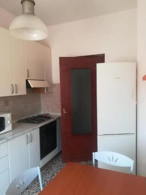 White cabinets stove and refrigerator kitchen at Comfy 2 bedroom apartment close to Palazzo Ducale in Parma Student Accommodation