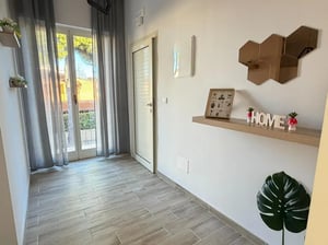 Wooden floor door grey curtains and shelf Entryway at Amazing bedroom in Pescara in Pescara Student Accommodation
