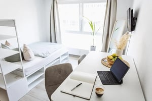 Bed shelves desk laptop notebook coffee fruits bedroom at Charming apartment nearby Magdeburg Cathedral in Magdeburg Student Accommodation
