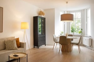 Sofa cabinet dining table chairs living room at Stylish central apartment nearby Magdeburg Hasselbachplatz in Magdeburg Student Accommodation