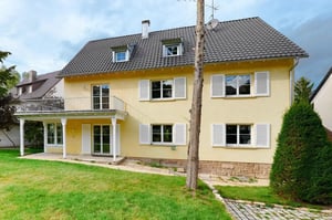 Yellow house with balcony lawn and tree exterior at Bright bedroom in a 4-bedroom apartment in Stuttgart in Stuttgart Student Accommodation