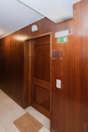 Wooden door exit sign and room number Corridor at Sublime 1_Bedroom Sea Beach Apartment in Matosinhos Student Accommodation