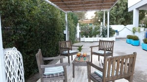 Wooden chairs table two glasses exterior area at 1-Bedroom flat in San Cataldo in Lecce Student Accommodation